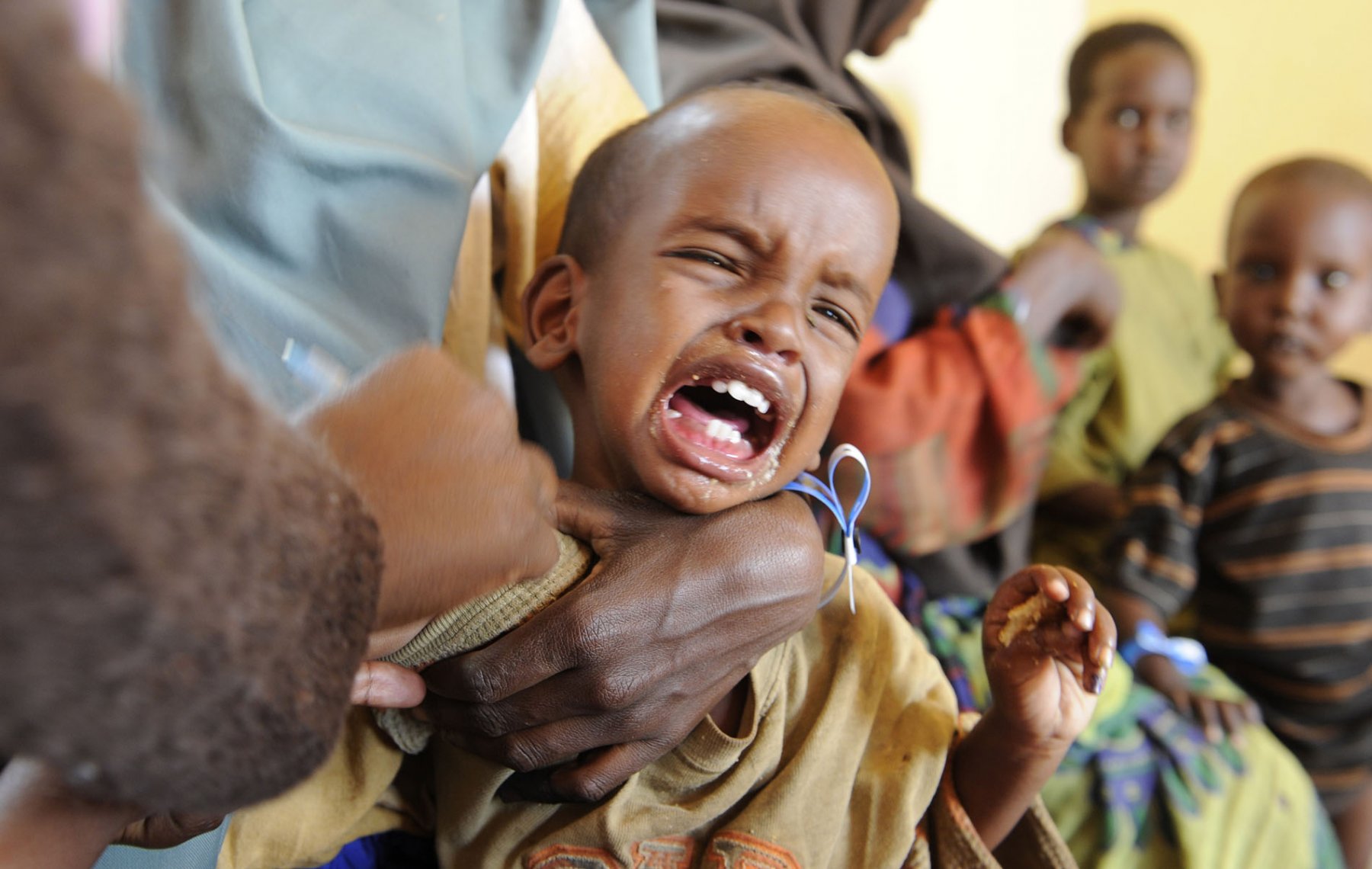 A little Somalian boy receives his first vaccination in a refugee camp in Dadaab, northeastern Kenya Wednesday, August 3, 2011 after his arrival at the camp. Somalia and parts of Kenya have been struck by one of the worst droughts and famines in six decades, more than 350.000 refugees have found shelter in the world's biggest refugee camp. Photo: Boris Roessler dpa  +++(c) dpa - Bildfunk+++