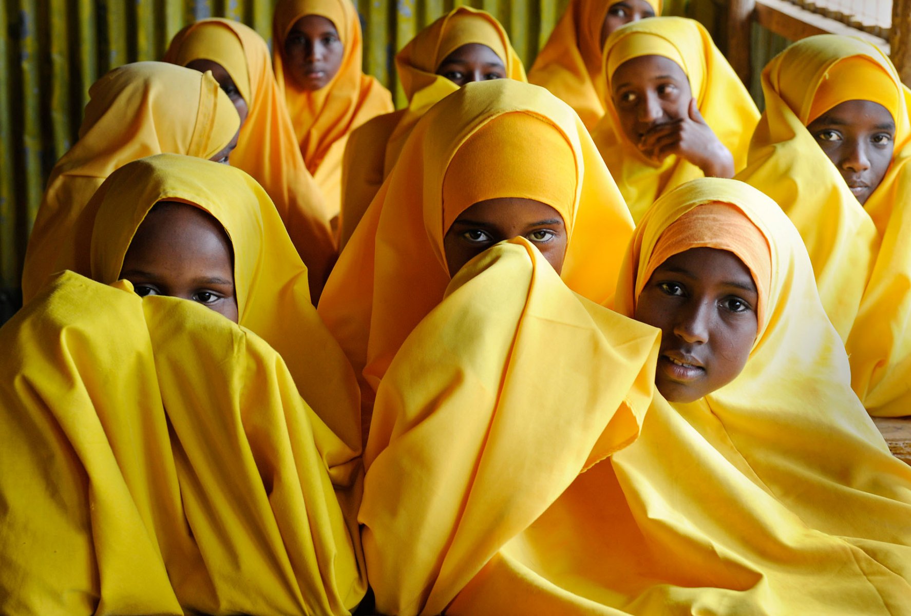 Girls hiding their faces from the photographer at a school inside a refugee camp in Dadaab, northeastern Kenya on friday, August 5, 2011. Within the camps infrastructure, the schools are a major importance. Somalia and parts of Kenya have been struck by one of the worst droughts and famines in six decades, more than 350.000 refugees have found shelter in the worlds biggest refugee camp. Foto: Boris Roessler dpa