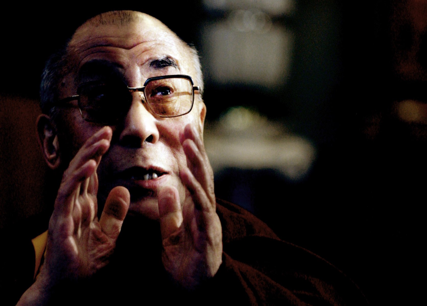The Dalai Lama pictured at his exile residence in Dharamsala, India, while discussing political Topics with western visitors. Photo: Boris Roessler/dpa