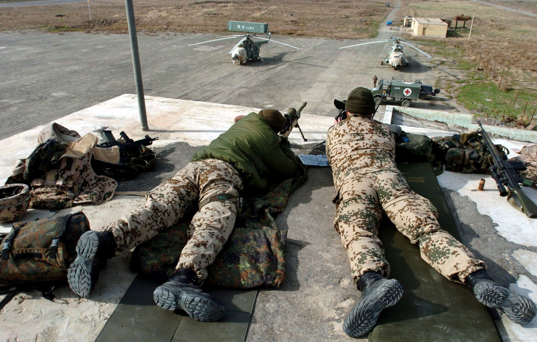 A team of snipers lying on the rooftop of the tower guard the airport in Kundus, Afghanistan. The building is guarded by paratroopers, who are also in charge to run the airport. Photo: Boris Roessler/dpa